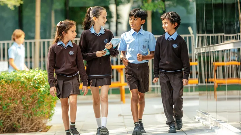 Four students chat as they walk together across the campus